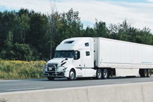 All white truck driving on the highway | Featured image for the Tips for Buying Your First Semi Truck Blog for Truck Finance Australia